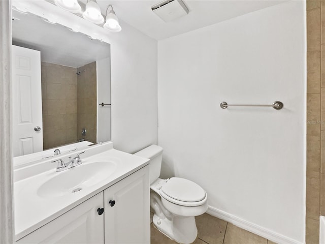 bathroom featuring toilet, tile floors, and large vanity