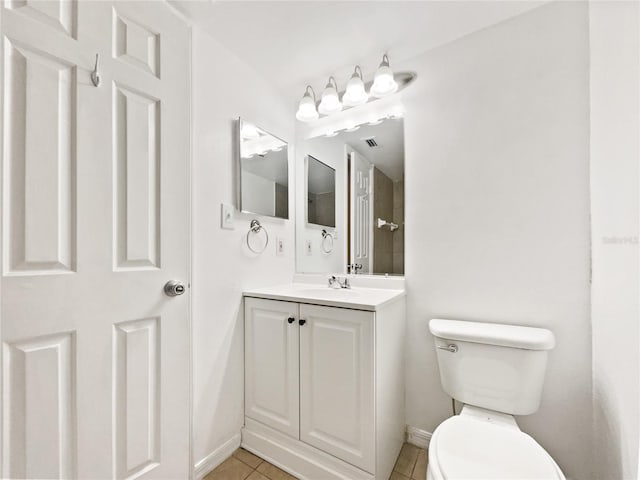 bathroom with tile floors, oversized vanity, and toilet