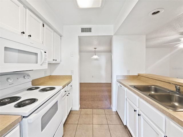 kitchen with white cabinetry, light tile floors, white appliances, and sink