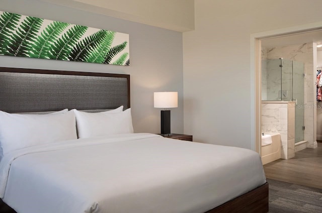 bedroom featuring connected bathroom and dark hardwood / wood-style floors