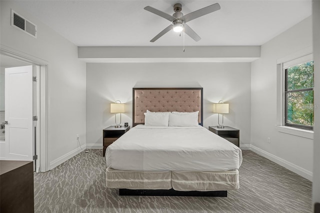 bedroom featuring ceiling fan and dark carpet