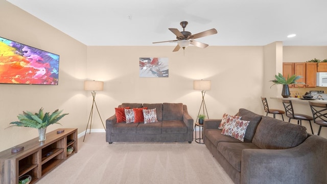 living room with ceiling fan and light colored carpet