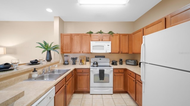 kitchen featuring sink, light tile patterned floors, and white appliances