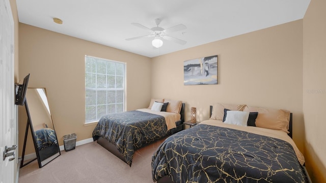 carpeted bedroom with multiple windows and ceiling fan