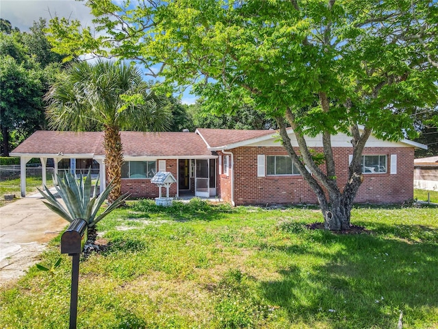 ranch-style home with a front lawn