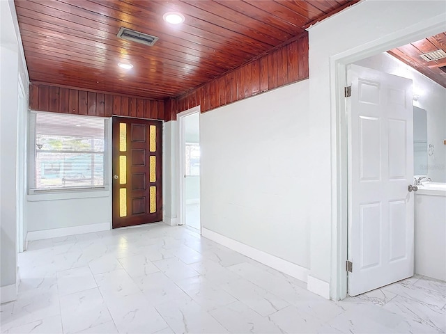 tiled spare room with wood walls and wood ceiling