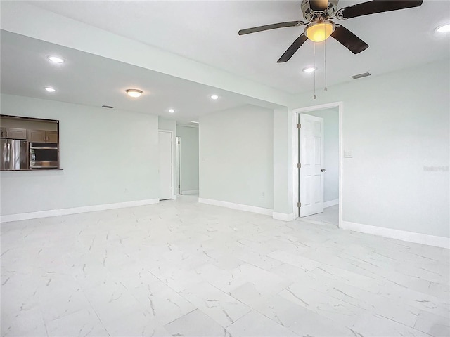 unfurnished room with ceiling fan and light tile flooring