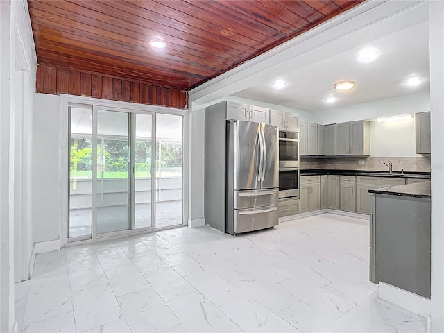 kitchen with stainless steel appliances, light tile floors, and wooden ceiling