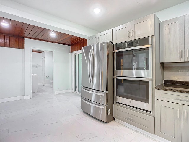 kitchen featuring wooden ceiling and appliances with stainless steel finishes