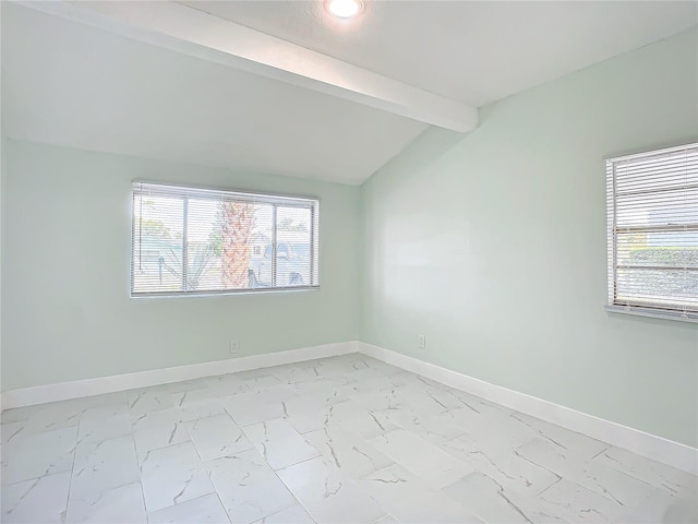 spare room featuring vaulted ceiling with beams and light tile floors