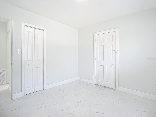 unfurnished bedroom with light tile floors