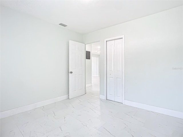 unfurnished room with light tile flooring