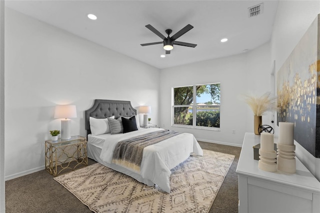 bedroom with ceiling fan and dark colored carpet