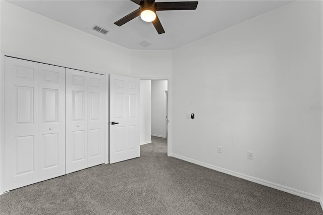 unfurnished bedroom featuring a closet, ceiling fan, and dark carpet