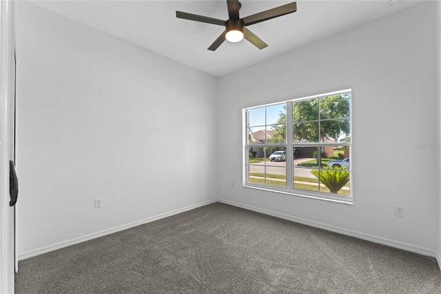 unfurnished room featuring ceiling fan and carpet flooring