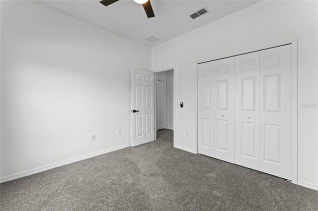 unfurnished bedroom with a closet, ceiling fan, and dark colored carpet