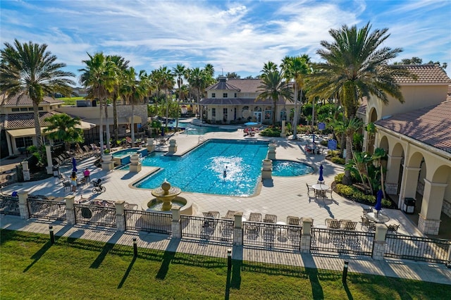 view of swimming pool with a patio and a lawn