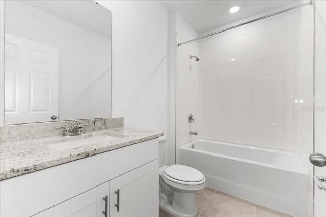 full bathroom featuring vanity, tiled shower / bath, toilet, and tile patterned flooring