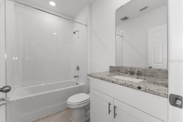 full bathroom with vanity, toilet, tile patterned floors, and tiled shower / bath combo