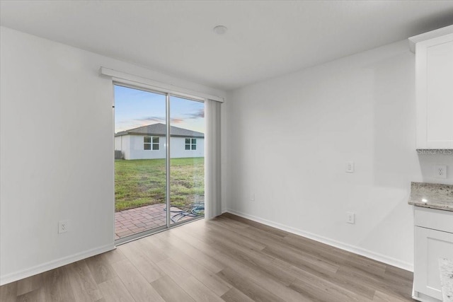 unfurnished dining area featuring light hardwood / wood-style flooring