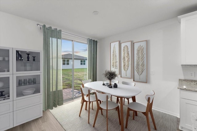 dining area with light hardwood / wood-style flooring