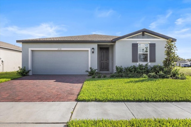 ranch-style house with a front yard and a garage