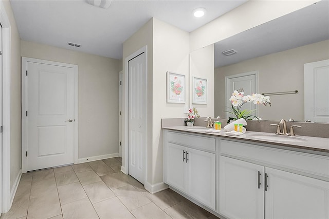 bathroom with dual bowl vanity and tile floors