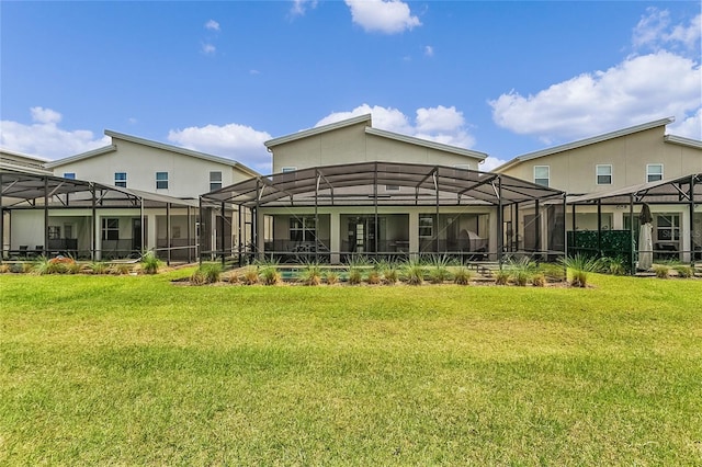 back of property with a lanai and a yard