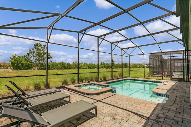 view of pool featuring a lanai, an in ground hot tub, and a patio area