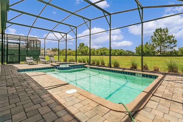 view of swimming pool with a patio area, an in ground hot tub, and glass enclosure