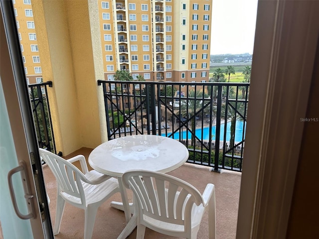 balcony featuring a swimming pool