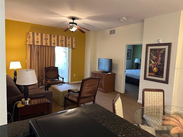 carpeted living room with ceiling fan