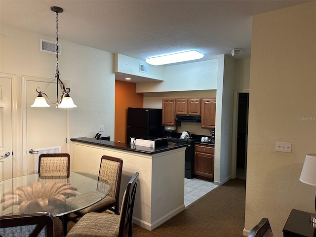 kitchen featuring kitchen peninsula, electric stove, light carpet, pendant lighting, and black refrigerator