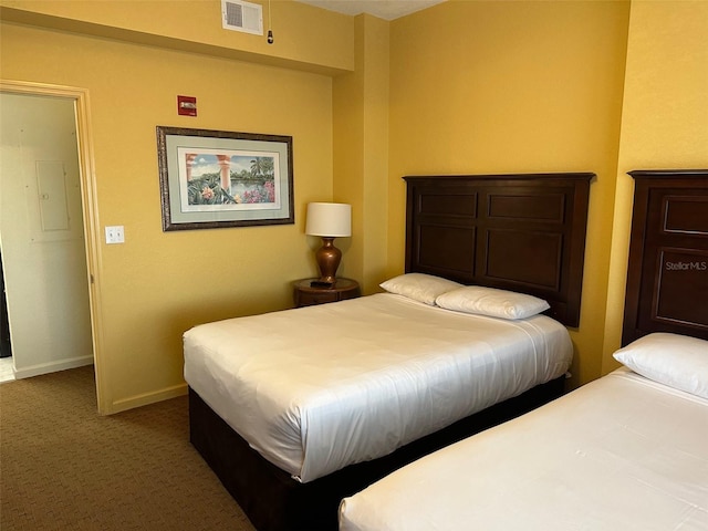 bedroom with dark colored carpet