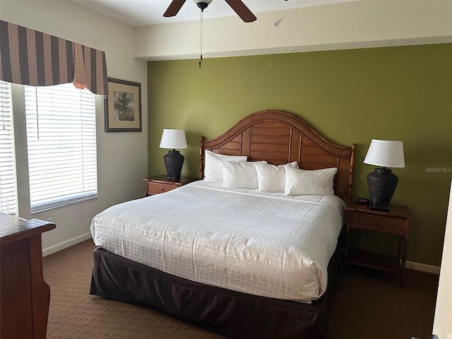 carpeted bedroom with ceiling fan and multiple windows