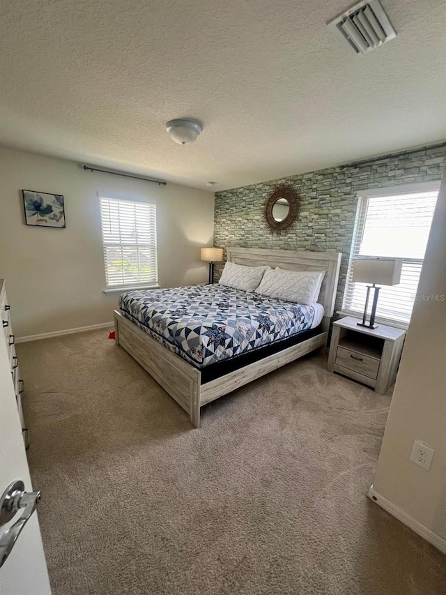 carpeted bedroom featuring a textured ceiling