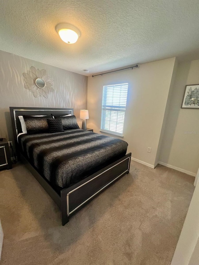 bedroom with carpet flooring and a textured ceiling