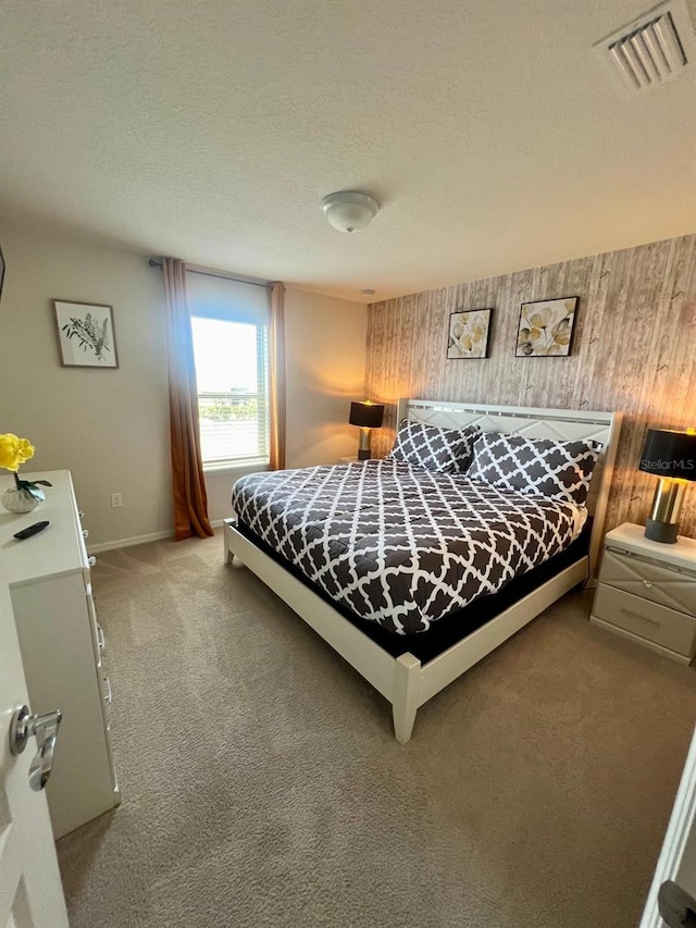 bedroom featuring carpet flooring and a textured ceiling