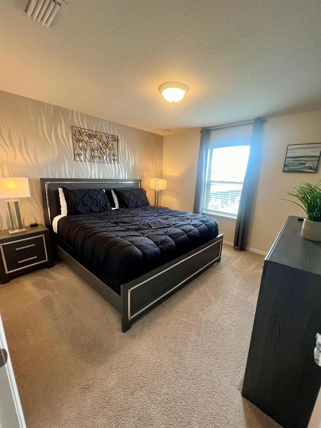 carpeted bedroom with a textured ceiling