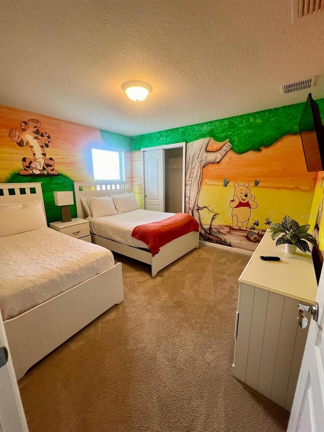 carpeted bedroom featuring a closet and a textured ceiling