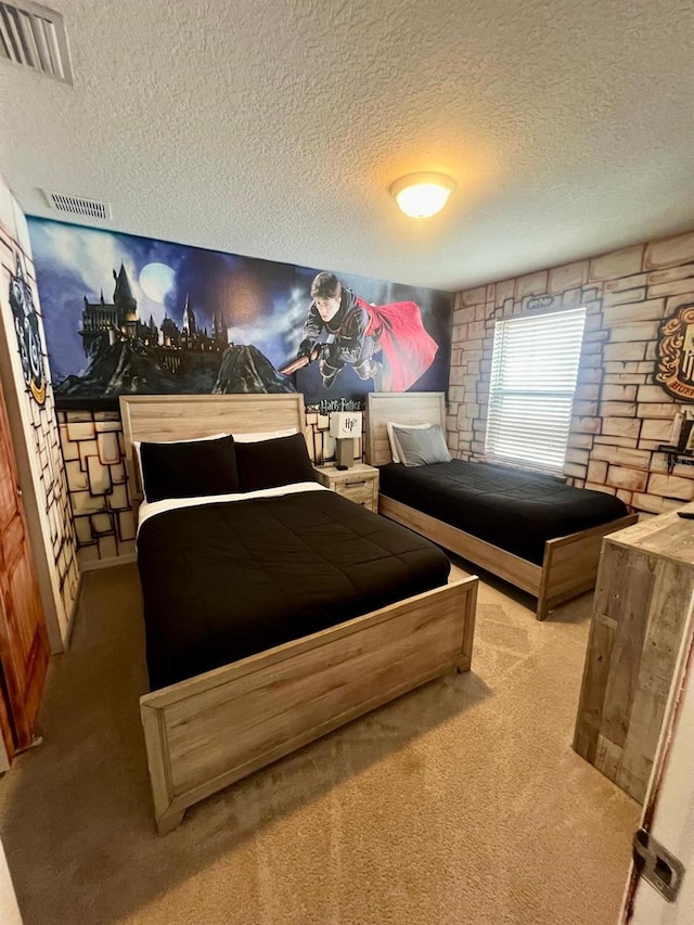 carpeted bedroom featuring a textured ceiling