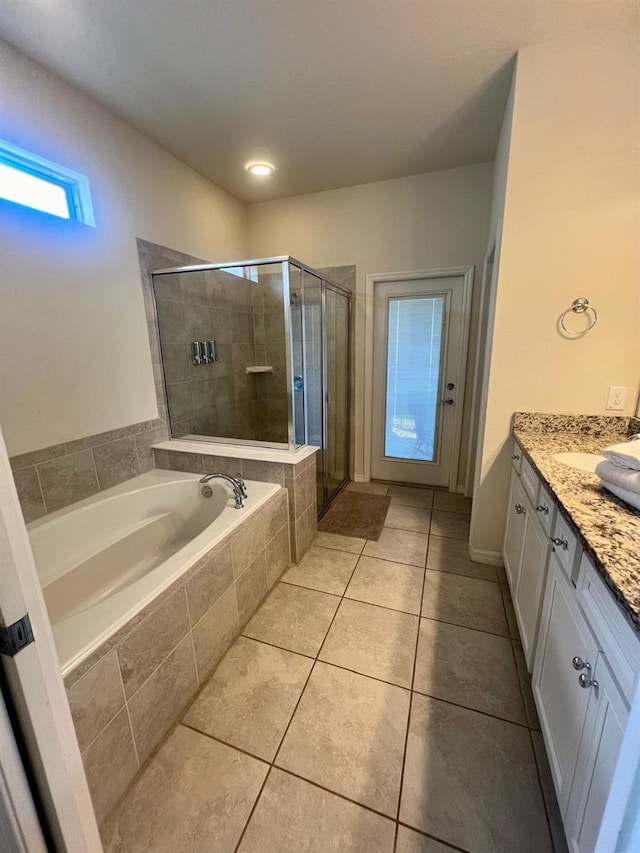 bathroom featuring vanity, shower with separate bathtub, and tile flooring