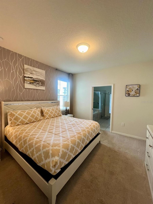 carpeted bedroom featuring connected bathroom and a textured ceiling