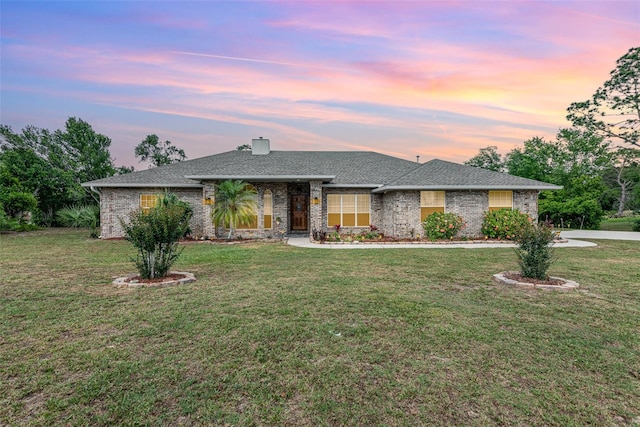 single story home featuring a yard