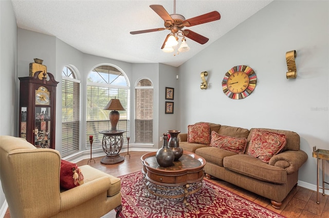 living room featuring a textured ceiling, hardwood / wood-style floors, ceiling fan, and vaulted ceiling