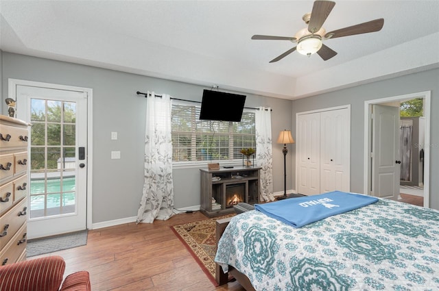 bedroom featuring a closet, light hardwood / wood-style floors, and ceiling fan