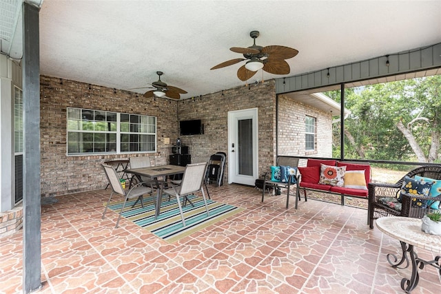 view of terrace with an outdoor living space and ceiling fan