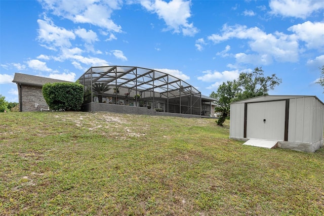 view of yard with a shed and glass enclosure