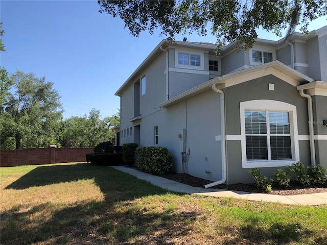 view of home's exterior with a lawn