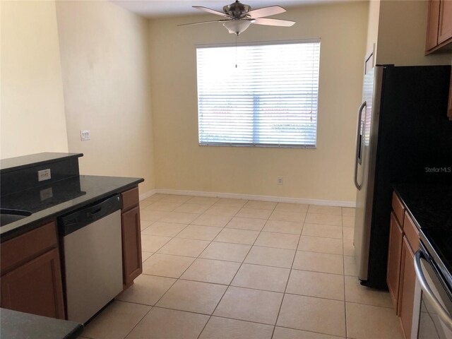 kitchen with ceiling fan, appliances with stainless steel finishes, and light tile patterned flooring